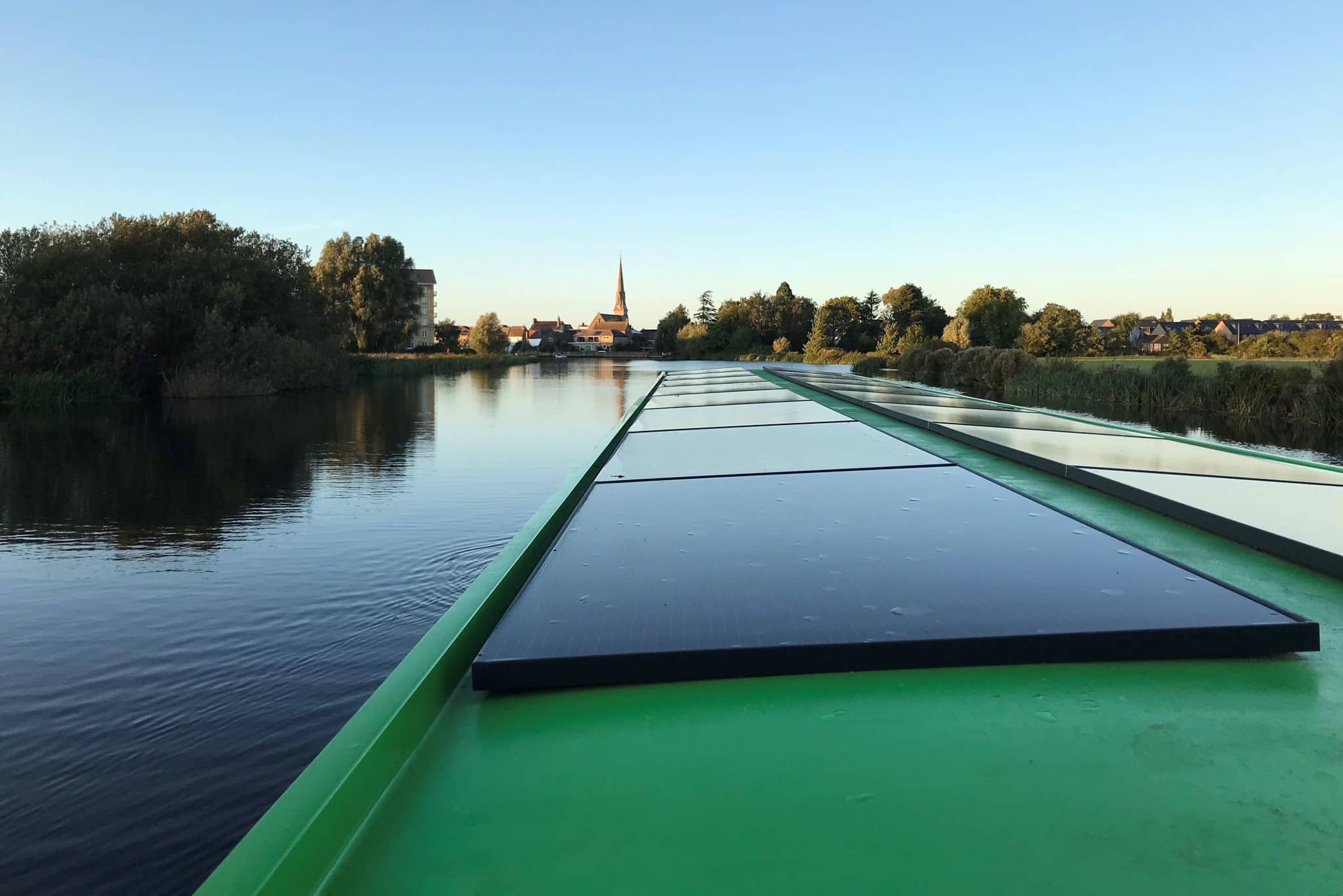 View across solar panels on River Great Ouse